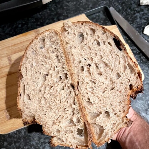 A scored sourdough loaf, freshly baked.