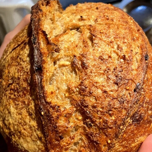 A rustic sourdough loaf with an open crumb.